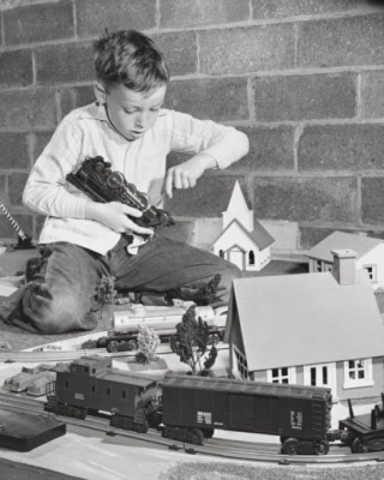 Boy Playing with a Train Set Poster Print