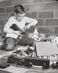 Boy Playing with a Train Set Poster Print
