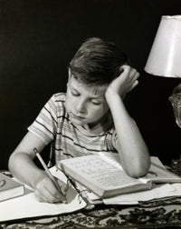Close-Up of a Boy Studying Poster Print showcasing a moment of concentration.