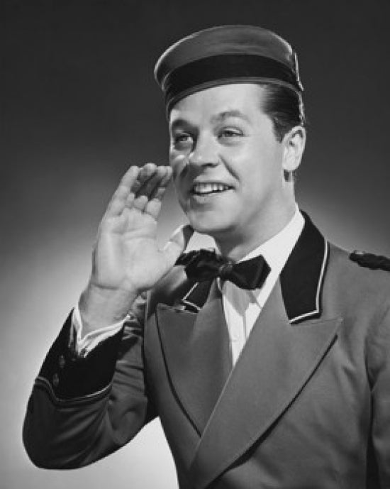 Close-up poster print of a bellhop talking with hand near mouth.
