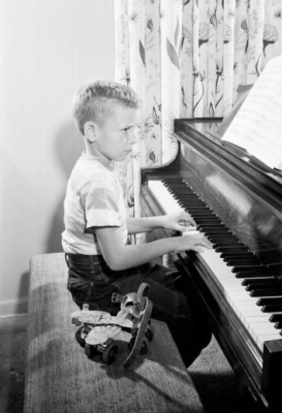 Side profile of a boy playing piano poster print