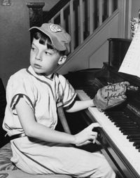 Side profile of a boy playing piano poster print showcasing musical passion.