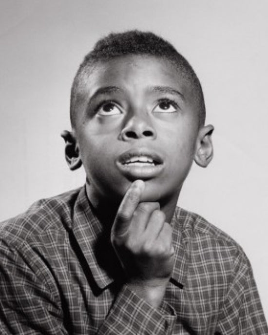 Close-up of a boy looking up poster print, capturing childhood wonder.