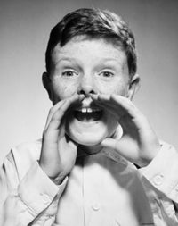 Close-up of a boy shouting with hands cupped around his mouth poster print.