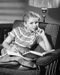 Poster print of a girl sitting with a book, perfect for home decor.