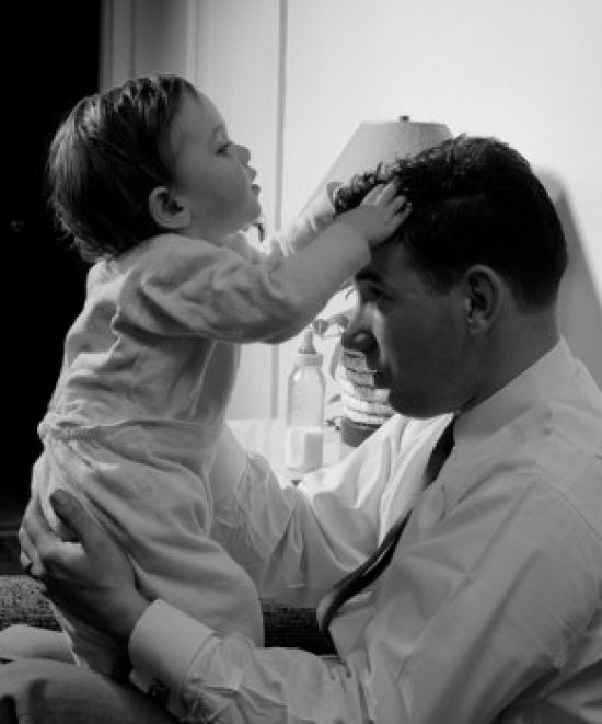 Father Holding Son at Home Poster Print showcasing love and connection.