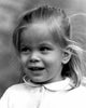 Girl smiling, looking away poster print showcasing joy and positivity.