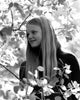 Girl standing among leaves on tree poster print
