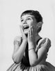 Girl smiling with hands on chin poster print
