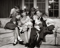 Family Sitting in the Living Room Poster Print showcasing warmth and togetherness.