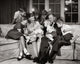 Family Sitting in the Living Room Poster Print showcasing warmth and togetherness.