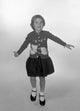 Studio portrait of a girl wearing a knitted jumper, cozy and inviting.