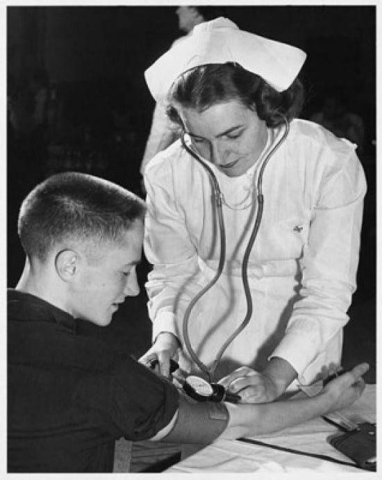Female nurse checking a young man's blood pressure poster print.
