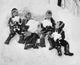 Four children playing in snow poster print capturing winter joy.