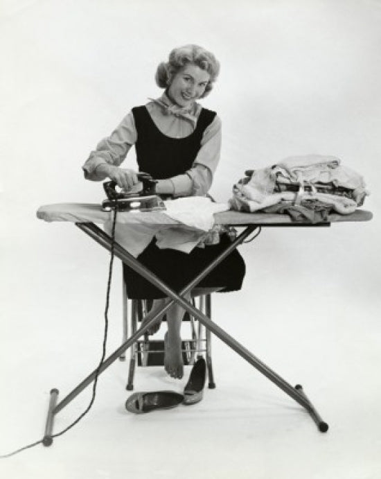 Portrait of a young woman ironing clothes poster print.