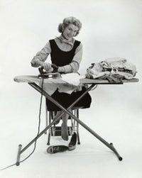 Portrait of a young woman ironing clothes poster print.