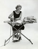 Portrait of a young woman ironing clothes poster print.