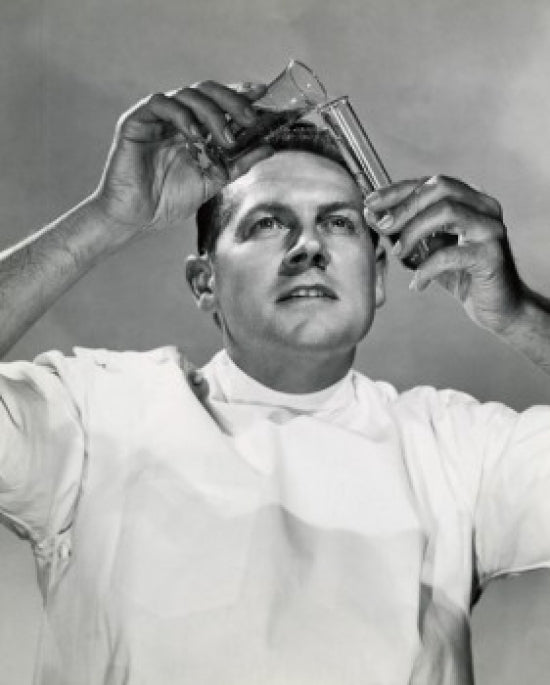 Close-up of a scientist pouring a chemical into a test tube poster print