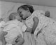 Baby Lying with Sister on Bed Poster Print, a heartwarming sibling love scene.