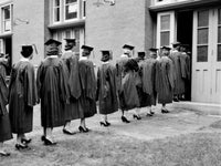 Graduation Day Poster Print featuring rear view of female students in gowns.