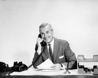 Businessman talking on the telephone in an office poster print
