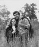 Young couple embracing in a field poster print.