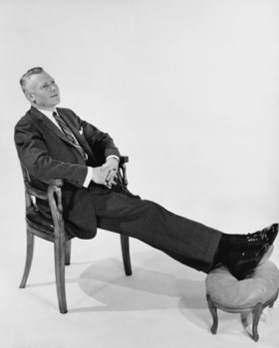High angle view of a businessman resting on an armchair poster print.
