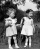 Cheerful girls in white dresses standing outdoors poster print