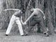 Two boys arm-wrestling on a lawn poster print.