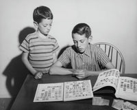 Poster print featuring two children looking at a collection of postage stamps.