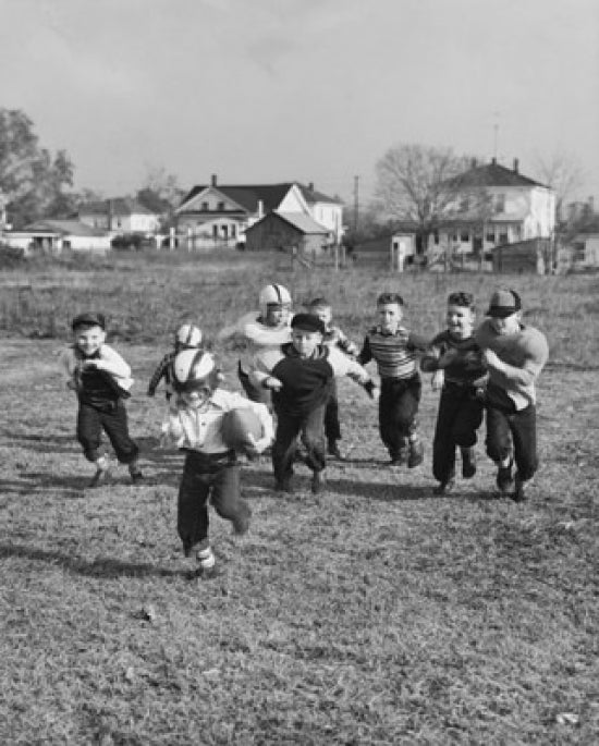 Group of boys playing football poster print showcasing dynamic youth sports.