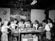 Group of boys working in a carpentry workshop poster print.