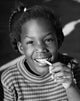 Portrait of a girl pulling bubble gum from her mouth poster print