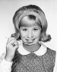 Portrait of a young woman smiling and holding a spoon, poster print.