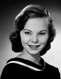 Portrait of a beautiful young woman smiling in studio shot.