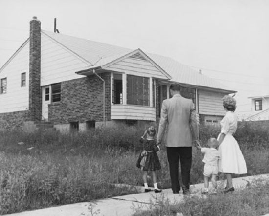 Family Togetherness Poster Print featuring a mid-adult couple with two children in front of a house.