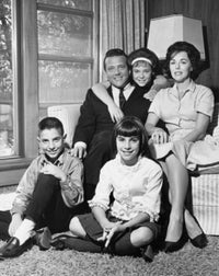 Family portrait poster print featuring a couple with three children in a living room.
