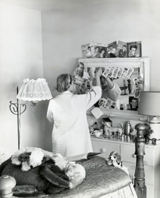Poster print of a teenage girl standing in front of a mirror in a bedroom, 1961.
