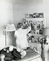 Poster print of a teenage girl standing in front of a mirror in a bedroom, 1961.