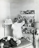 Poster print of a teenage girl standing in front of a mirror in a bedroom, 1961.