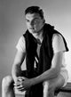 Young man sitting and looking away poster print