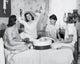 Poster print of four teenage girls sitting on a bed together, capturing a moment of friendship.