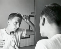 1960 poster print of a teenage boy combing hair in front of a mirror