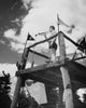 Low angle view of a teenage boy blowing a bugle at scout camp poster print