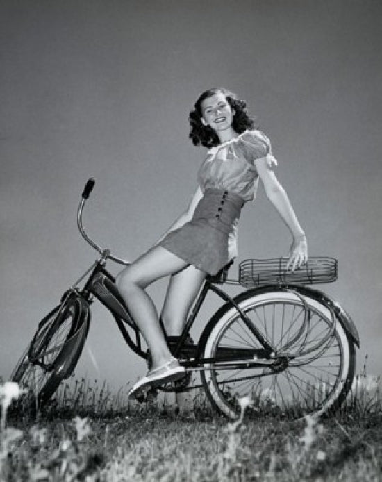 Poster print of a teenage girl smiling while sitting on a bicycle