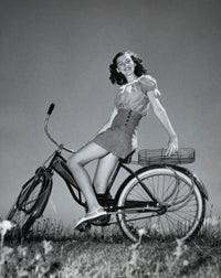 Poster print of a teenage girl smiling while sitting on a bicycle