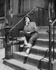Teenage girl sitting on steps looking upset poster print