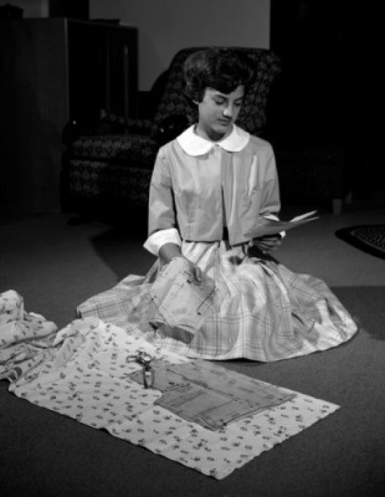 Young Woman Preparing for Sawing Dress Poster Print showcasing an artistic scene.