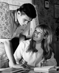Teenage boy and girl studying together poster print