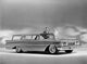 Man and woman standing near a 1959 Oldsmobile Super 88 Fiesta poster print.